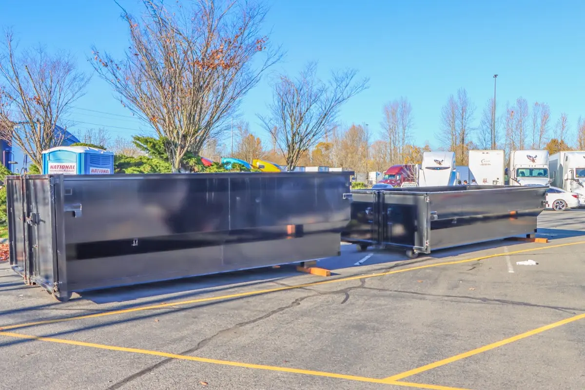 Professional dumpster rental service with roll-off container on residential driveway in Carneys Point